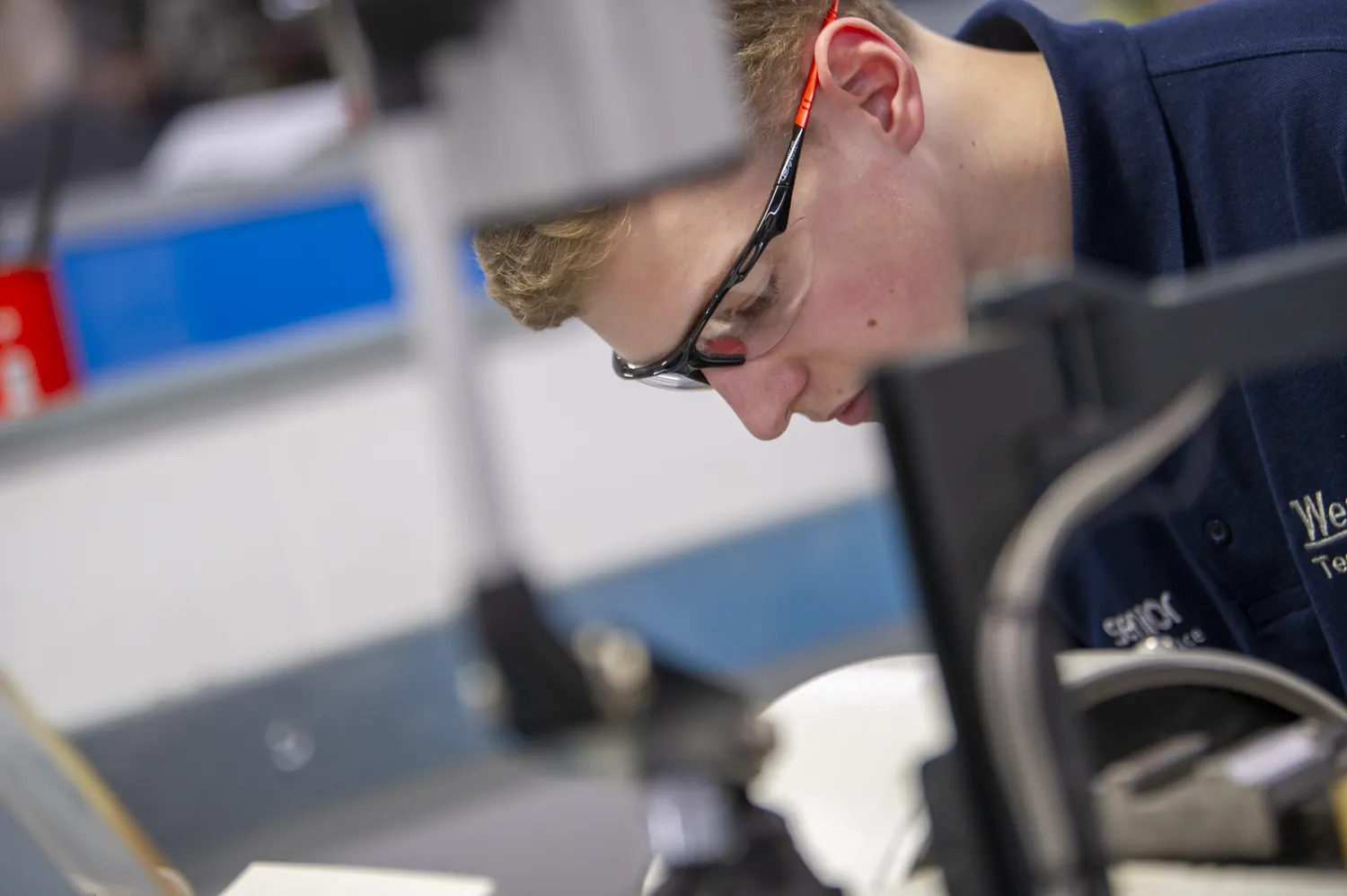 engineering apprentice using equipment