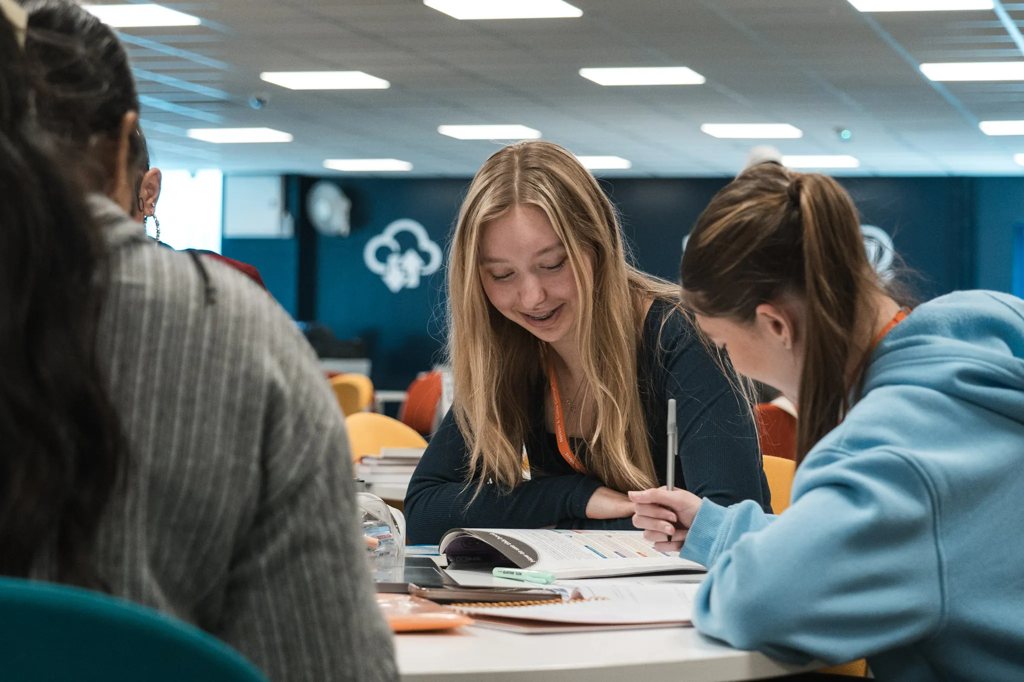 Three students studying around a table