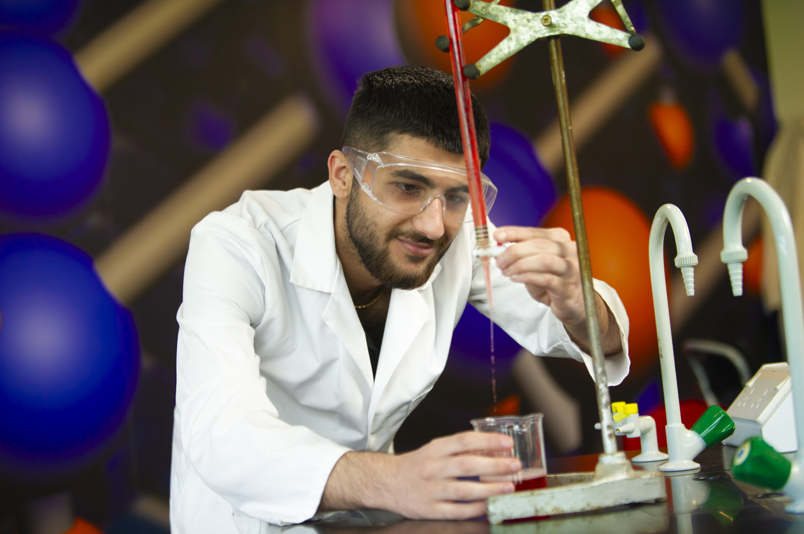 Student using science equipment in the lab